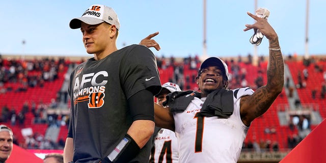 Cincinnati Bengals quarterback Joe Burrow, left, and wide receiver Ja'Marr Chase (1) celebrate after the AFC championship NFL football game against the Kansas City Chiefs, Sunday, Jan. 30, 2022, in Kansas City, Mo. The Bengals won 27-24 in overtime.