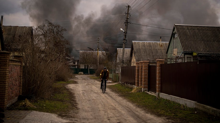 Ukrainian man rides bicycle in Irpin