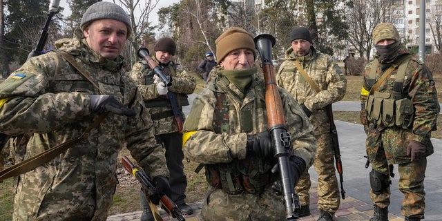 Ukrainian Territorial Defense Forces members hold an anti-tank weapon in a park on the outskirts of Kyiv, Ukraine, March 9, 2022. 