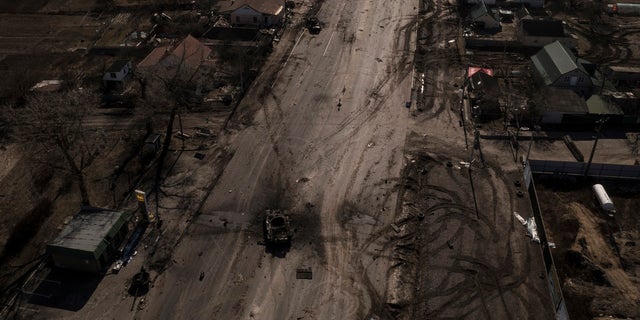 Destroyed Russian tanks are seen on a main road 