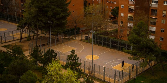 People play basketball in a basketball court covered with dust as storm Celia blew sand from the Sahara desert at the the Cerro del Tio Pio park in Madrid, Spain.