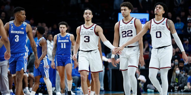 Gonzaga guard Andrew Nembhard (3), forward Anton Watson (22) and guard Julian Strawther (0) react during the second half of a second-round NCAA Tournament game against Memphis March 19, 2022, in Portland, Ore. Gonzaga won 82-78.