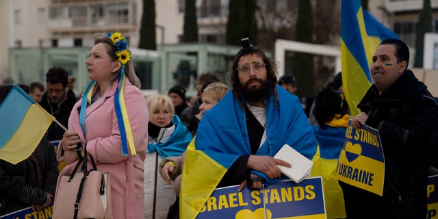 People gather in Habima Square in Tel Aviv, Israel, to watch Ukrainian President Volodymyr Zelenskyy in a video address to the Knesset, Israel's parliament