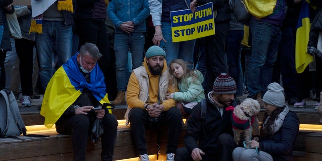 People gather in Habima Square in Tel Aviv, Israel, to watch Ukrainian President Volodymyr Zelenskyy in a video address to the Knesset, Israel's parliament