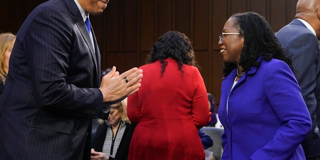 Supreme Court nominee Judge Ketanji Brown Jackson greets Sen. Cory Booker, D-N.J., as she arrives for her confirmation hearing before the Senate Judiciary Committee Monday, March 21, 2022, on Capitol Hill in Washington. (AP Photo/Jacquelyn Martin)