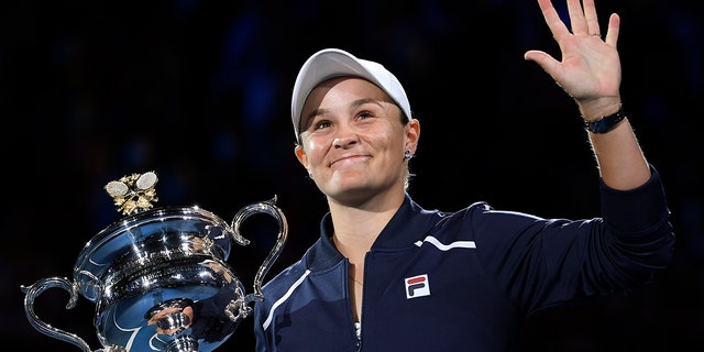 Ash Barty of Australia waves as she holds the Daphne Akhurst Memorial Cup after defeating Danielle Collins of the U.S., in the women's singles final at the Australian Open tennis championships in Melbourne, Australia on Jan. 29, 2022.