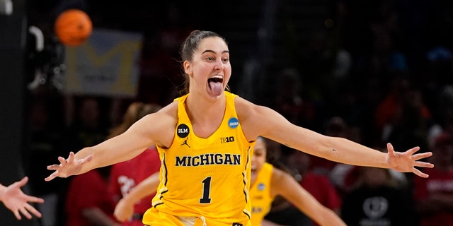 Michigan's Amy Dilk (1) celebrates a 52-49 victory over South Dakota following a game in the Sweet 16 round of the NCAA women's tournament Saturday, March 26, 2022, in Wichita, Kan. 