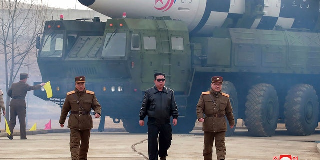 In this photo distributed by the North Korean government, North Korean leader Kim Jong Un, center, walks around what it says a Hwasong-17 intercontinental ballistic missile (ICBM) on the launcher, at an undisclosed location in North Korea on March 24, 2022.