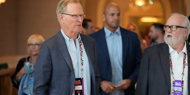 New York Giants co-owner, president and CEO John Mara, front left, arrives for a presentation at the start of the NFL football owners meeting, Sunday, March 27, 2022, at The Breakers resort in Palm Beach, Fla.