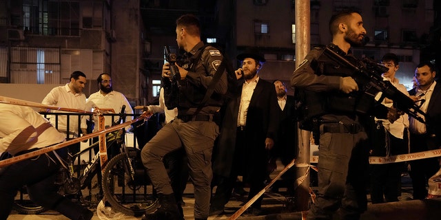 Police secure the site where a gunman opened fire in Bnei Brak, Israel, Tuesday, March 29, 2022.