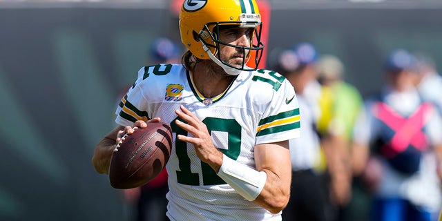 Green Bay Packers quarterback Aaron Rodgers (12) throws against the Cincinnati Bengals in the first half of an NFL football game in Cincinnati, Sunday, Oct. 10, 2021. 