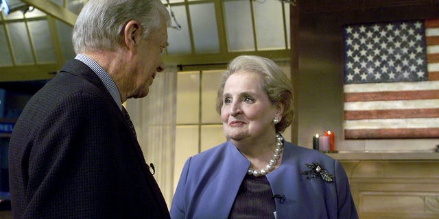 Former President Jimmy Carter talks with Secretary of State Madeline Albright in New York, Jan. 8, 2001.