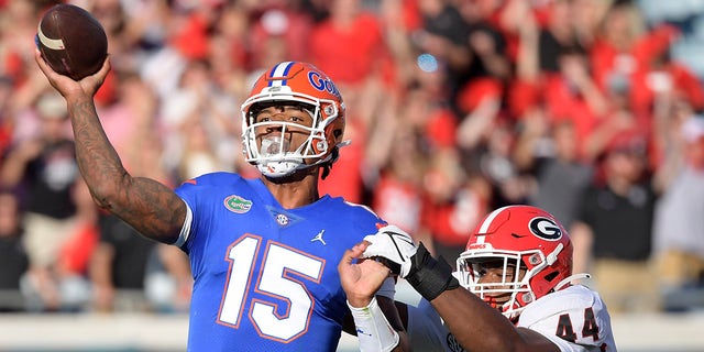 Florida quarterback Anthony Richardson (15) throws a pass while under pressure from Georgia defensive lineman Travon Walker (44) during the first half of an NCAA college football game, Saturday, Oct. 30, 2021, in Jacksonville, Fla.