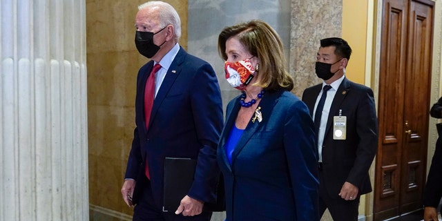 President Joe Biden walks with House Speaker Nancy Pelosi of Calif., on Capitol Hill in Washington, Friday, Oct. 1, 2021, for a meeting with the House Democratic caucus to try to resolve an impasse around the bipartisan infrastructure bill. 