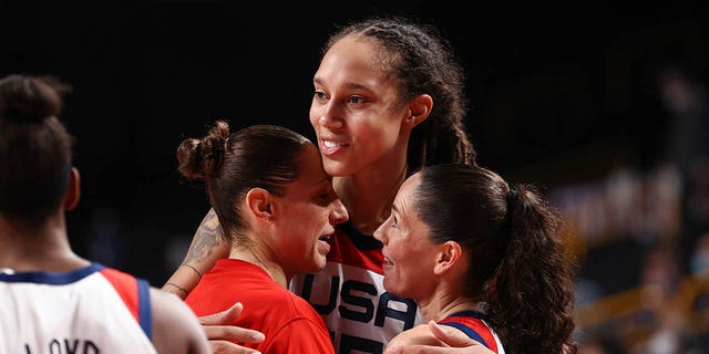 Sue Bird, right, and Diana Taurasi, left, embrace with Brittney Griner, center, of the USA Women's National Team after winning the Gold Medal Game of the 2020 Summer Olympics in Tokyo, Aug. 8, 2021.