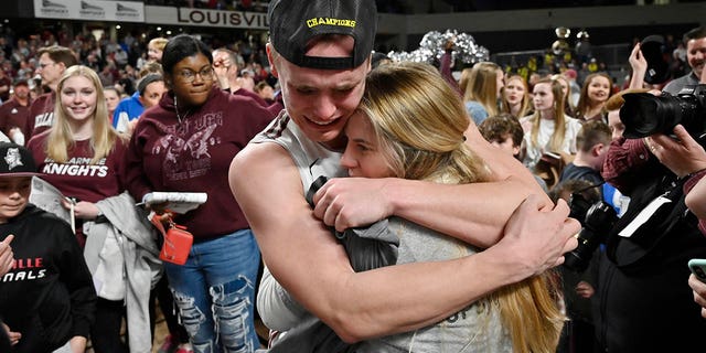 Bellarmine guard CJ Fleming hugs his fiancee, Lexy Hoffman, after Bellarmine's 77-72 victory over Jacksonville in an NCAA college basketball game for the championship in the Atlantic Sun Conference tournament in Louisville, Kentucky, Tuesday, March 8, 2022.
