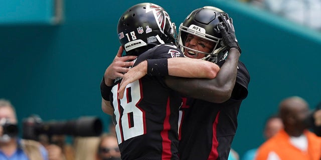 Atlanta Falcons wide receiver Calvin Ridley (18) celebrates scoring a touchdown with Atlanta Falcons quarterback Matt Ryan (2), during the first half of an NFL football game against the Miami Dolphins, Sunday, Oct. 24, 2021, in Miami Gardens, Fla.