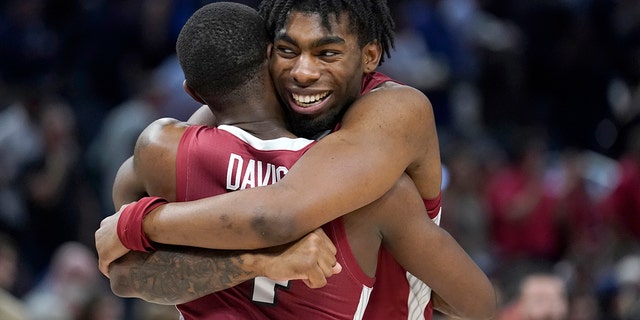 Arkansas guard Davonte Davis, left, celebrates with forward Kamani Johnson after Arkansas defeated Gonzaga in a college basketball game in the Sweet 16 round of the NCAA tournament in San Francisco, Thursday, March 24, 2022.