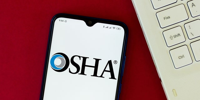 The Occupational Safety and Health Administration (OSHA) logo seen displayed on a smartphone in an illustration on Aug. 24, 2020. 