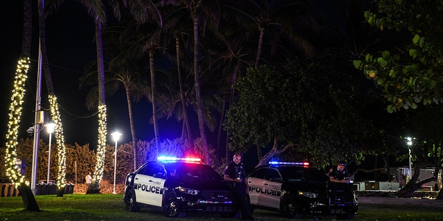 A Miami Beach police officer stands guard on Ocean Drive in Miami Beach, Florida, on March 22, 2021.