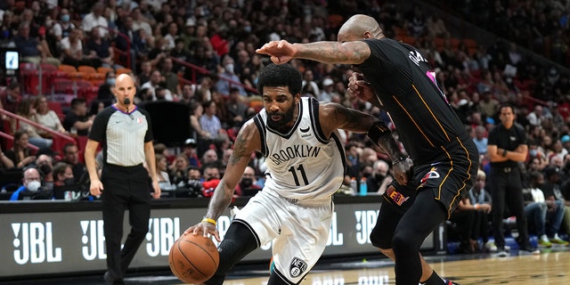 Kyrie Irving #11 of the Brooklyn Nets drives to the basket during the game against the Miami Heat on February 12, 2022 at FTX Arena in Miami, Florida.