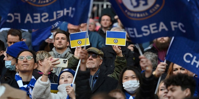 Chelsea supporters hold up Ukrainian flags ahead of the English League Cup final football match between Chelsea and Liverpool at Wembley Stadium on Feb. 27, 2022.