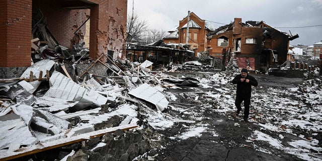 A man walks between houses destroyed during air strikes on the central Ukranian city of Bila Tserkva on March 8, 2022.