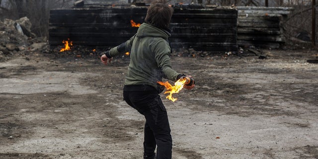 Civilians make Molotov cocktails and train amid Russian attacks in Lviv, Ukraine, March 8, 2022. 