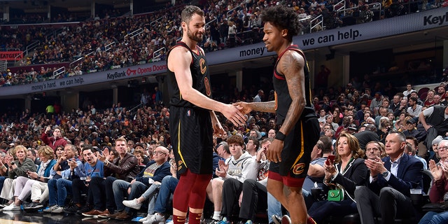 Kevin Love #0 of the Cleveland Cavaliers high fives Brandon Goodwin #00 of the Cleveland Cavaliers during the game against the Los Angeles Lakers on March 21, 2022, at Rocket Mortgage FieldHouse in Cleveland, Ohio.