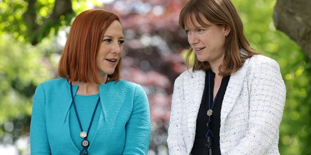 White House Press Secretary Jen Psaki (L) and White House Communications Director Kate Bedingfield (R) wait for President Joe Biden to deliver remarks on the COVID-19 response and vaccination program in the Rose Garden of the White House on May 13, 2021 in Washington, DC. 