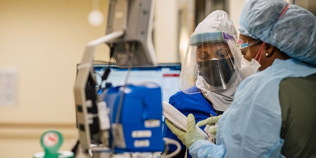 Emergency Room nurses speak to each other at the Houston Methodist The Woodlands Hospital on August 18, 2021, in Houston, Texas.