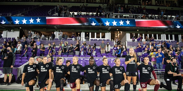 Orlando Pride players kneeling for the anthem before a game between Chicago Red Stars and Orlando Pride at Exploria Stadium on October 29, 2021, in Orlando, Florida.