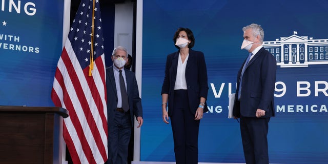 (L-R) Dr. Anthony Fauci, director of the National Institute of Allergy and Infectious Diseases and the chief medical adviser to the president; Centers for Disease Control and Prevention Director Rochelle Walensky; and White House coronavirus response coordinator Jeffrey Zients arrive for a video call with President Biden, the White House Covid-19 Response team and the National Governors Association in the South Court Auditorium at the Eisenhower Executive Office Building on Dec. 27, 2021, in Washington.