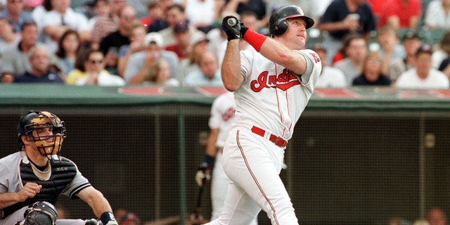 Cleveland Indians batter Jim Thome watches as his solo home run goes over the right field wall during the second inning against the New York Yankees 19 June at Jacobs Field in Cleveland, Ohio.