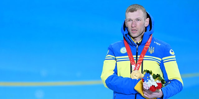 Gold medalist Grygorii Vovchynskyi of Team Ukraine poses during the Para Biathlon Men's Sprint Standing medal ceremony on day two of the Beijing 2022 Winter Paralympics at Zhangjiakou Medals Plaza on March 6, 2022, in Zhangjiakou, Hebei Province of China.