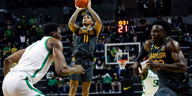 Baylor guard James Akinjo (11) shoots against Oregon during an NCAA college basketball game in Eugene, Ore., Saturday, Dec. 18, 2021.