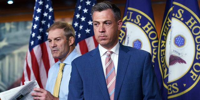 Rep. Jim Banks, R-Ind., center, and Rep. Jim Jordan, R-Ohio, left, exchange places at the podium during a news conference in Washington, Wednesday, July 21, 2021. 