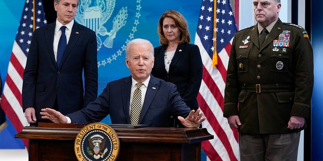 President Biden speaks after signing a delegation of authority in the South Court Auditorium on the White House campus in Washington, Wednesday, March 16, 2022. From left, Secretary of State Antony Blinken, Biden, Deputy Secretary of Defense Kathleen Hicks and Chairman of the Joint Chiefs of Staff General Mark Milley.