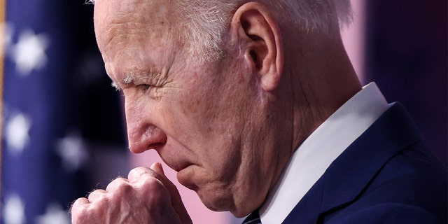 President Biden clears his throat as he announces new steps requiring government to buy more made-in-America goods during remarks in the Eisenhower Executive Office Building's South Court Auditorium at the White House in Washington, March 4, 2022.