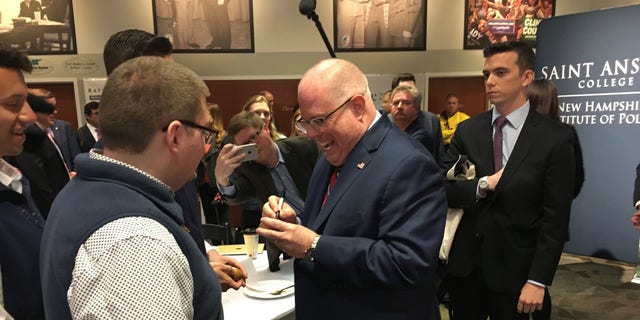 Maryland Gov. Larry Hogan signs the iconic wooden eggs during an appearance at the 'Politics and Eggs' speaking series at the New Hampshire Institute of Politics at Saint Anselm College, on April 23, 2019 in Goffstown, N.H. 