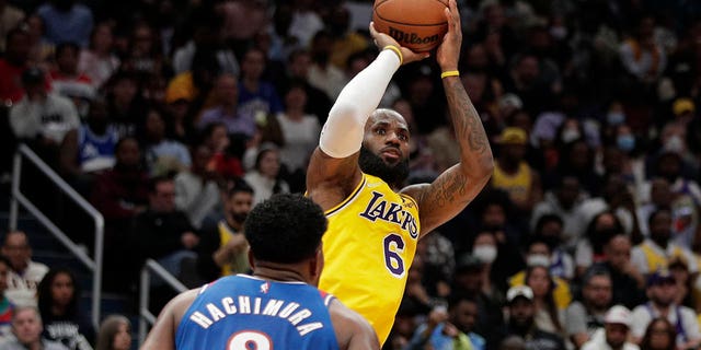 The Los Angeles Lakers' LeBron James (6) shoots as the Washington Wizards' Rui Hachimura (8) defends during the second half Saturday, March 19, 2022, in Washington.