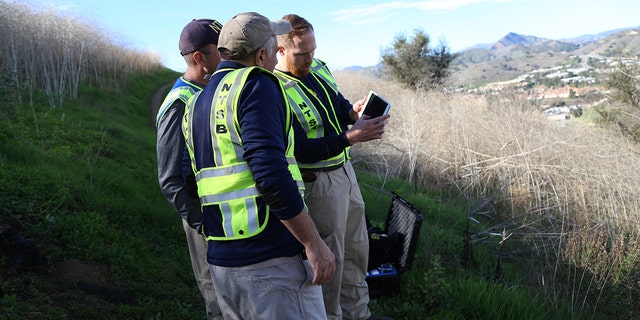 NTSB investigators reviewing coordinates to prepare a drone for mapping the site in Calabasas, Calif., where a helicopter crashed Sunday killing nine people, including Kobe Bryant and his 13-year-old daughter Gianna.