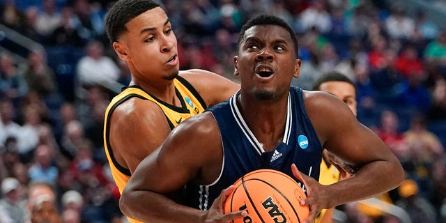 Richmond's Nathan Cayo (4) drives past Iowa's Keegan Murray (15) in the second half of a college basketball game during the first round of the NCAA men's tournament, Thursday, March 17, 2022, in Buffalo, N.Y.