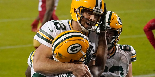 Green Bay Packers wide receiver Marquez Valdes-Scantling, bottom left, and quarterback Aaron Rodgers (12) celebrate after connecting on a touchdown pass against the San Francisco 49ers in Santa Clara, Calif., Nov. 5, 2020. 