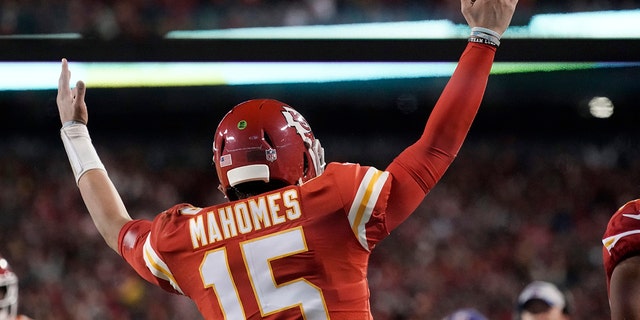 Kansas City Chiefs quarterback Patrick Mahomes (15) celebrates after scoring on an 8-yard touchdown run during the first half of an NFL divisional round playoff football game against the Buffalo Bills, Sunday, Jan. 23, 2022, in Kansas City, Mo.