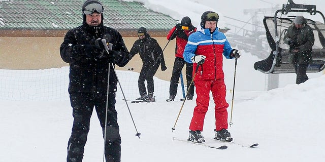 Russian President Vladimir Putin, right, and Belarusian President Alexander Lukashenko arrive at the mountain resort of Krasnaya Polyana near the Black Sea resort of Sochi, Russia, Monday, Feb. 22, 2021. 