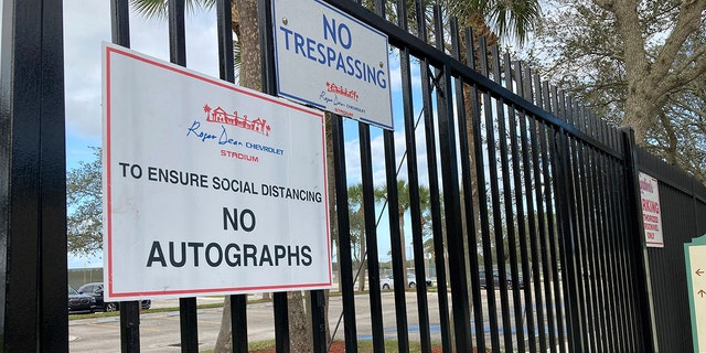 Signs are posted outside Roger Dean Stadium in Jupiter, Florida, Monday, Feb. 21, 2022. Baseball labor negotiations moved to the spring training ballpark from New York as players and owners join the talks, which enter a more intensive phase with perhaps a week left to salvage opening day on March 31.