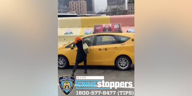 Alleged thief smashes taxi window with cinder block.