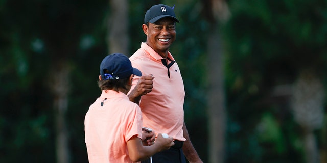 Tiger Woods reacts with his son Charlie Woods on the 16th green during the first round of the PNC Championship golf tournament Dec. 18, 2021, in Orlando, Fla.