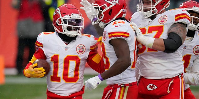 Kansas City Chiefs wide receiver Tyreek Hill (10) reacts with teammates after scoring a touchdown during the second half of an NFL football game against the Denver Broncos, Sunday, Oct. 25, 2020, in Denver.